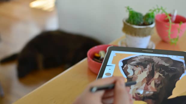 person drawing on tablet