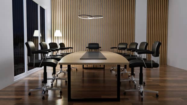 A conference table with nine chairs.