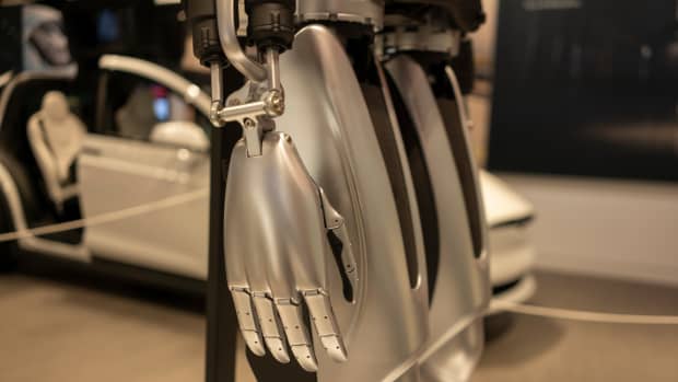 optimus robot hand while it's sitting on a stand