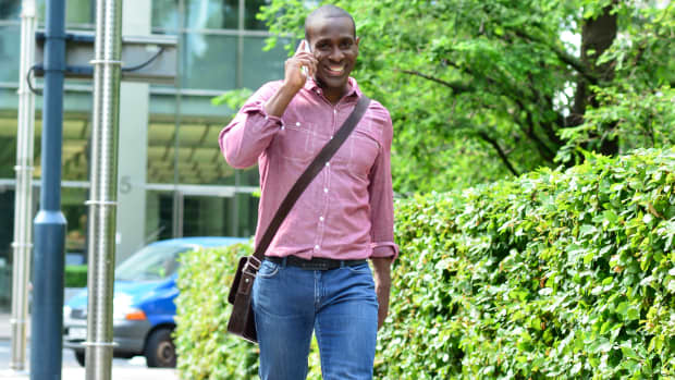 Man walking with cell phone.