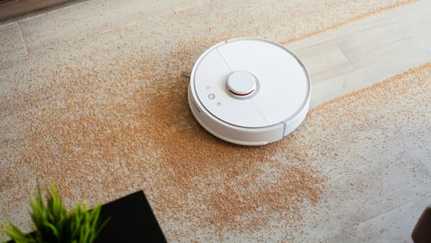A robot vacuum cleaning up dirt