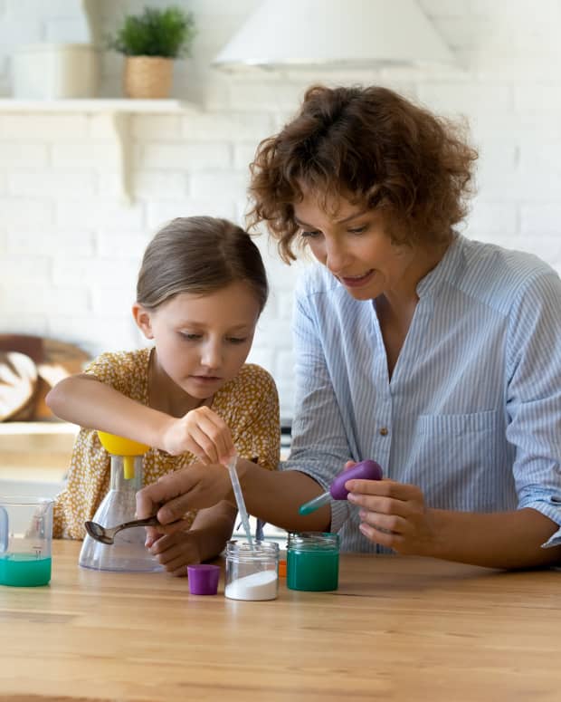 Parent and child doing science experiments at home
