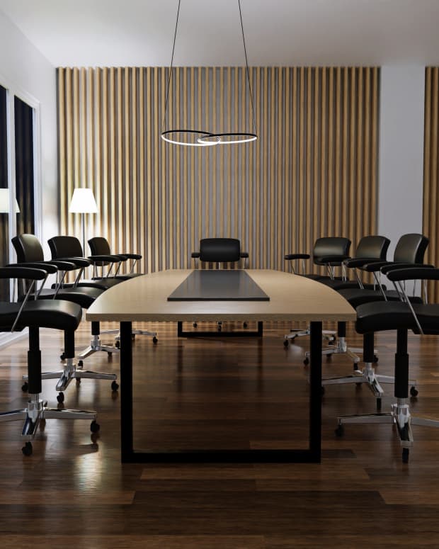 A conference table with nine chairs.