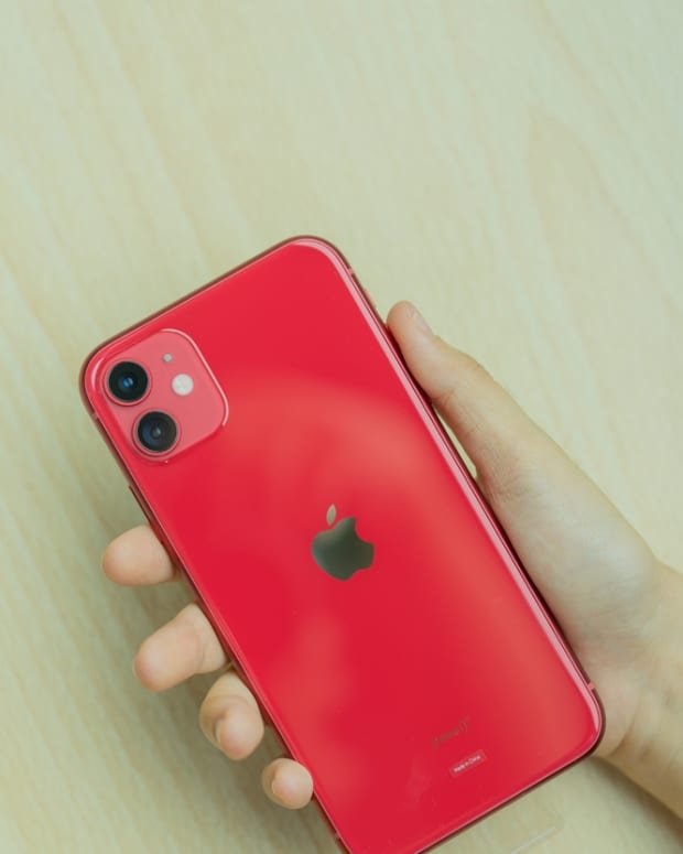 A red iPhone back showing cameras and flash