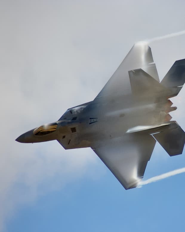 F-22 Raptor in front of clouds.