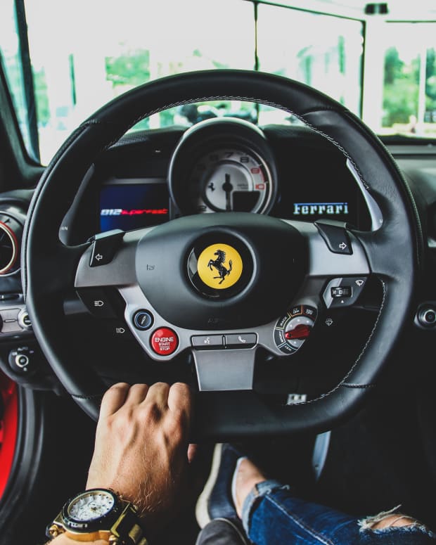 Ferrari driver behind wheel.