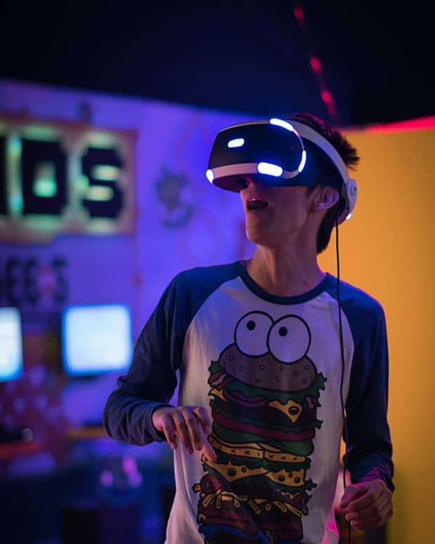 A man using a VR headset in an arcade.