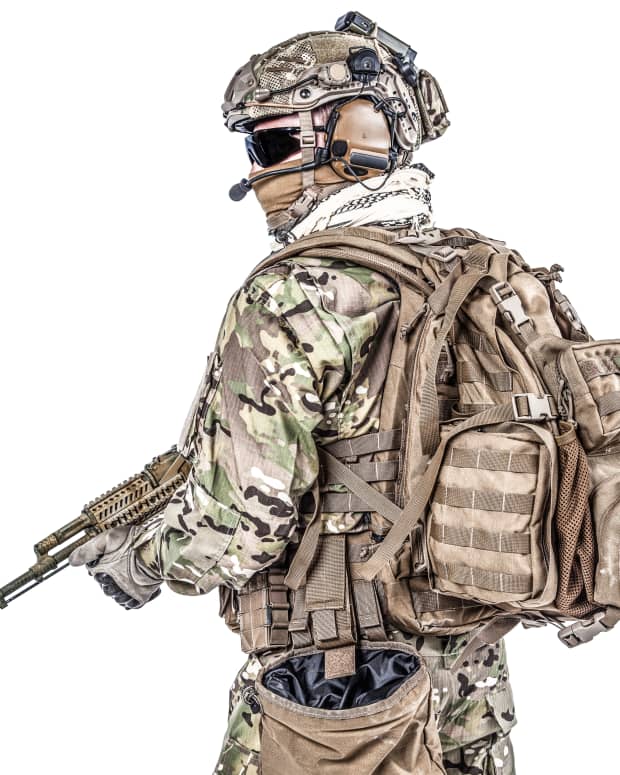Soldier with rifle and backpack.