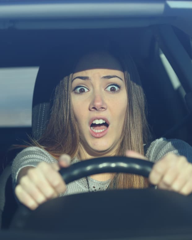 Surprised woman driving.