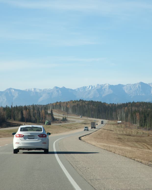 Highway shoulder with mountains in the distance.