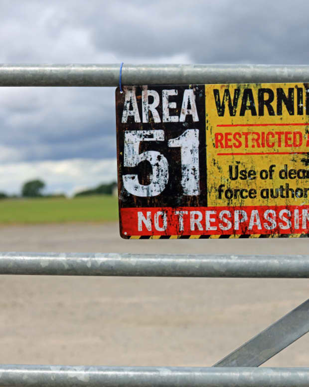 A sign on a fence bordering Area-51.