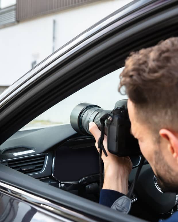 Man secretly takes photo from car.