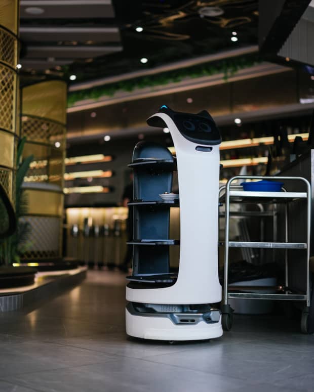 A robotic waiter serving food in a restaurant.