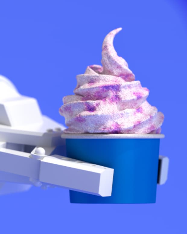 A robotic arm serving a cup of ice cream.