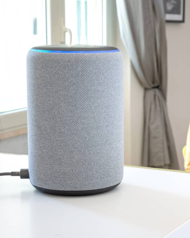 A man speaking with his Amazon Echo speaker