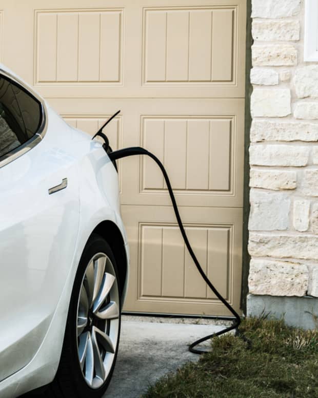 A Tesla charging outside a home